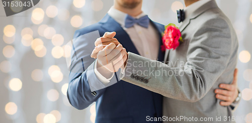 Image of close up of happy male gay couple dancing