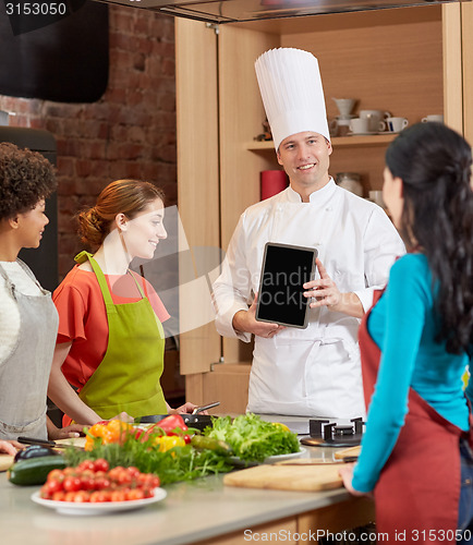Image of happy women with chef and tablet pc in kitchen