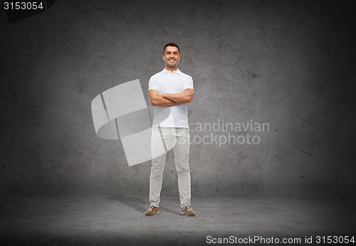 Image of smiling man in white t-shirt with crossed arms