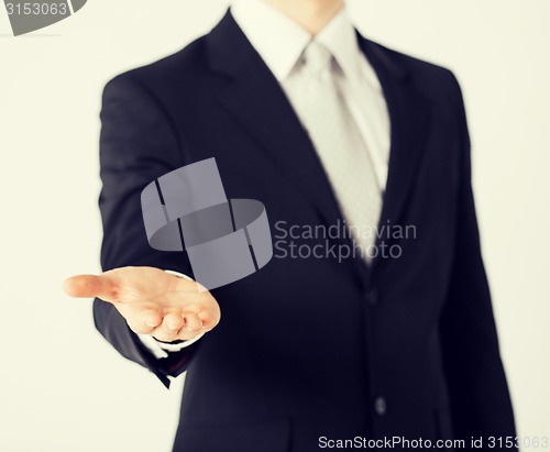 Image of mans hand showing something