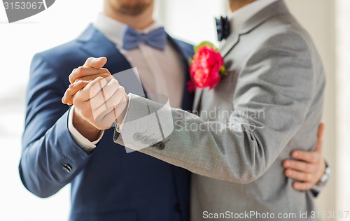 Image of close up of happy male gay couple dancing