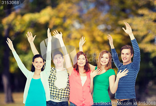 Image of group of smiling students waving hands