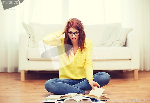 Image of stressed student girl reading books at home