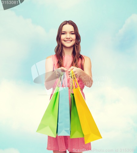 Image of smiling woman in dress with many shopping bags