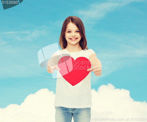 Image of beautiful little girl sitting at table