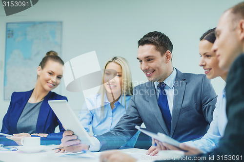 Image of business team with tablet pc having discussion