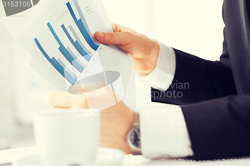 Image of businessman on meeting discussing graphics