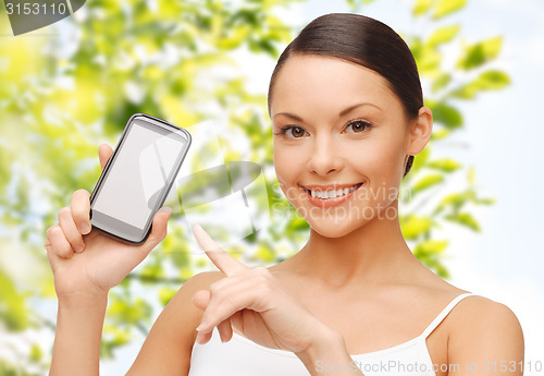 Image of happy woman showing smartphone blank screen