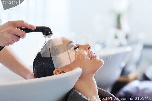 Image of happy young woman at hair salon