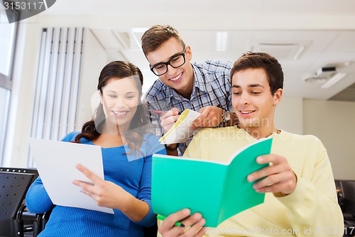 Image of group of smiling students in lecture hall