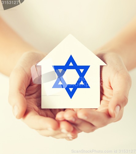 Image of hands holding house with star of david