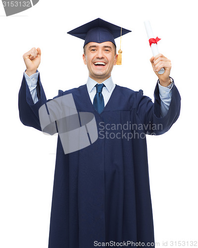 Image of smiling adult student in mortarboard with diploma