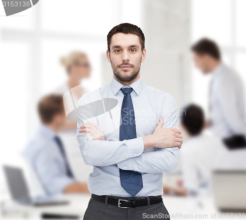 Image of handsome businessman with crossed arms