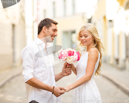 Image of couple with flowers in the city