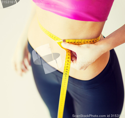 Image of trained belly with measuring tape