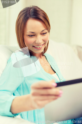 Image of happy woman with tablet pc computer at home