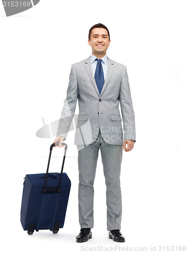 Image of happy businessman in suit with travel bag