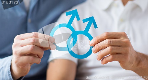 Image of close up of happy male gay couple with love symbol