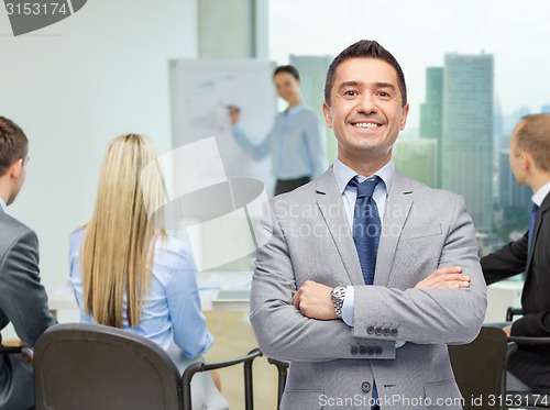 Image of happy smiling business team over office room