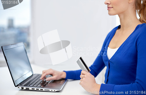 Image of close up of woman with laptop and credit card