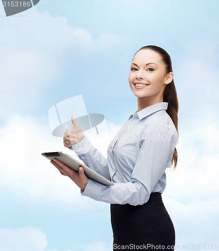 Image of smiling woman looking at tablet pc computer