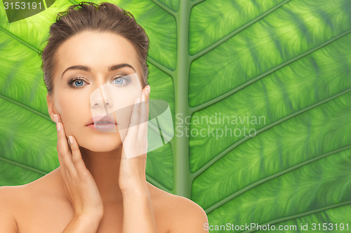 Image of beautiful young woman face over green background