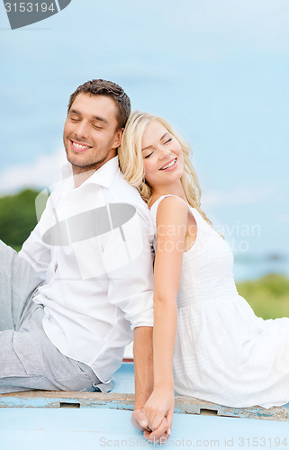 Image of smiling couple at sea side