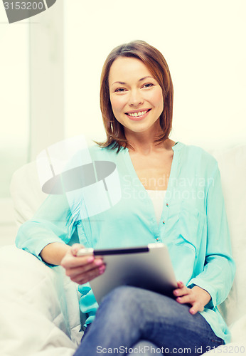 Image of smiling woman with tablet pc computer at home