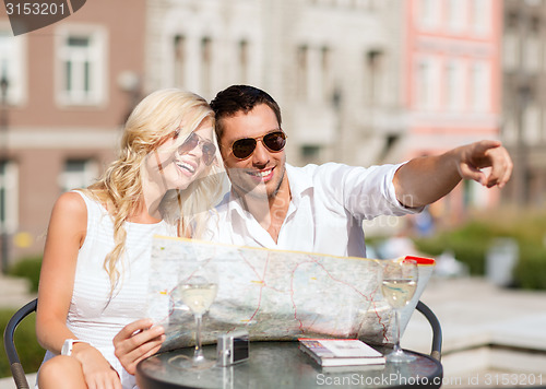 Image of couple with map in cafe