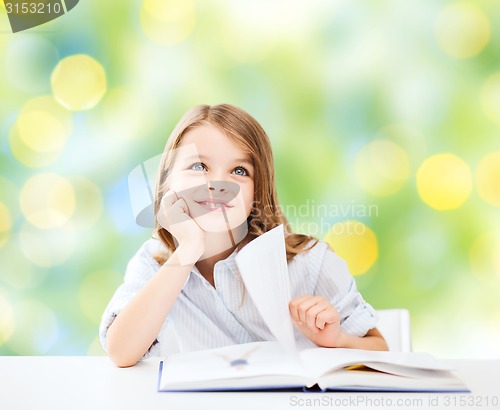 Image of happy student girl with book at school