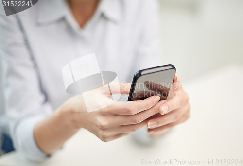 Image of close up of woman texting on smartphone at office