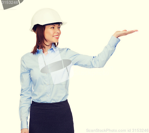 Image of young smiling businesswoman in white helmet