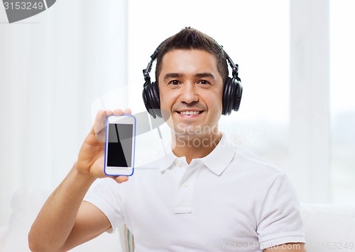 Image of happy man with smartphone and headphones