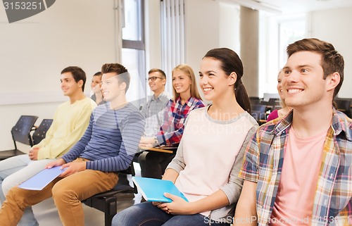 Image of group of smiling students in lecture hall