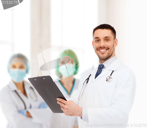 Image of smiling male doctor with clipboard and stethoscope