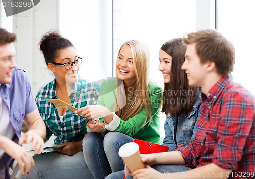 Image of students communicating and laughing at school