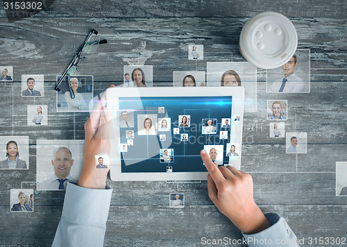 Image of close up of hands with tablet pc and network