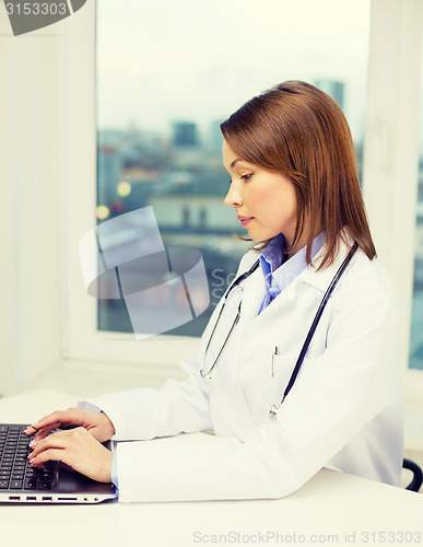 Image of busy doctor with laptop computer