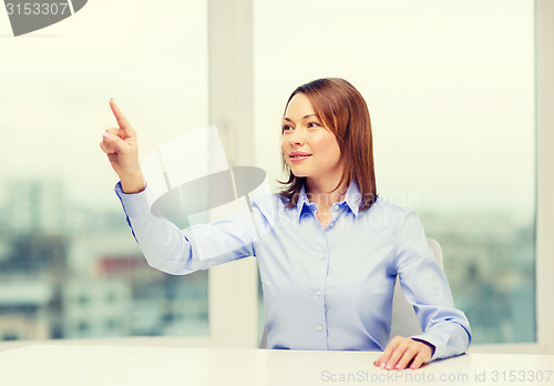 Image of smiling woman pointing to something imaginary