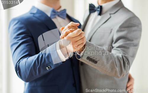 Image of close up of happy male gay couple dancing