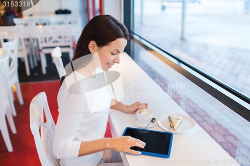 Image of smiling woman with tablet pc and coffee at cafe