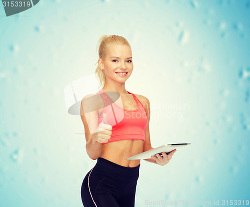 Image of smiling sporty woman with tablet pc computer