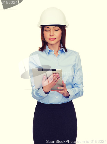 Image of young calm businesswoman in white helmet