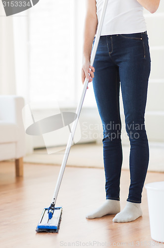 Image of close up of woman with mop cleaning floor at home