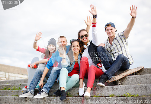 Image of group of smiling teenagers hanging out