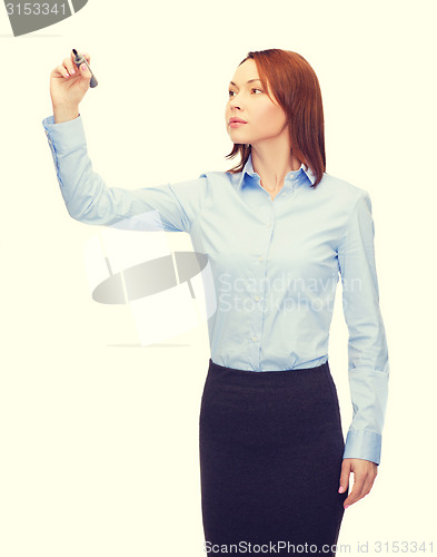 Image of businesswoman writing something in air with marker