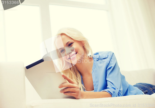 Image of smiling woman with tablet pc computer at home