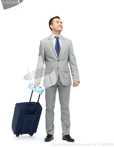 Image of happy businessman in suit with travel bag