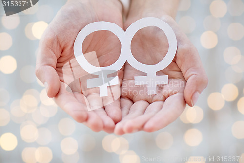 Image of close up of happy lesbian couple with venus symbol