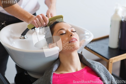 Image of happy young woman at hair salon